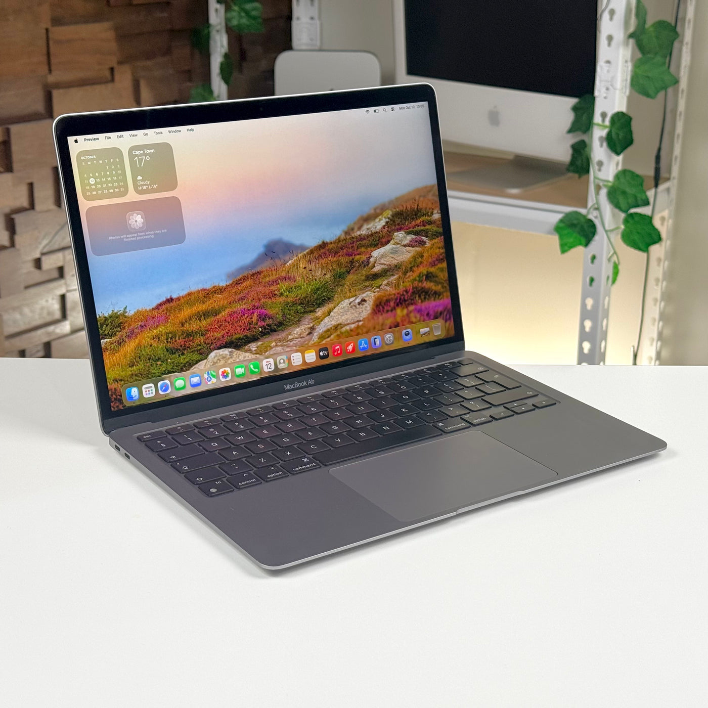 Pre-owned MacBook Air 13-inch M1 in Space Gray, open at an angle on a desk - Mac Shack