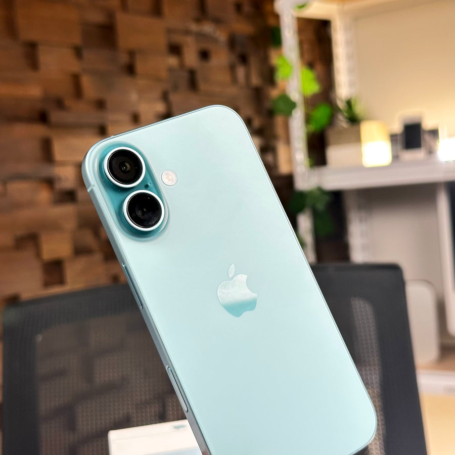 Angled back view of the pre-owned iPhone 16 in Teal showing the dual camera and Apple logo - Mac Shack