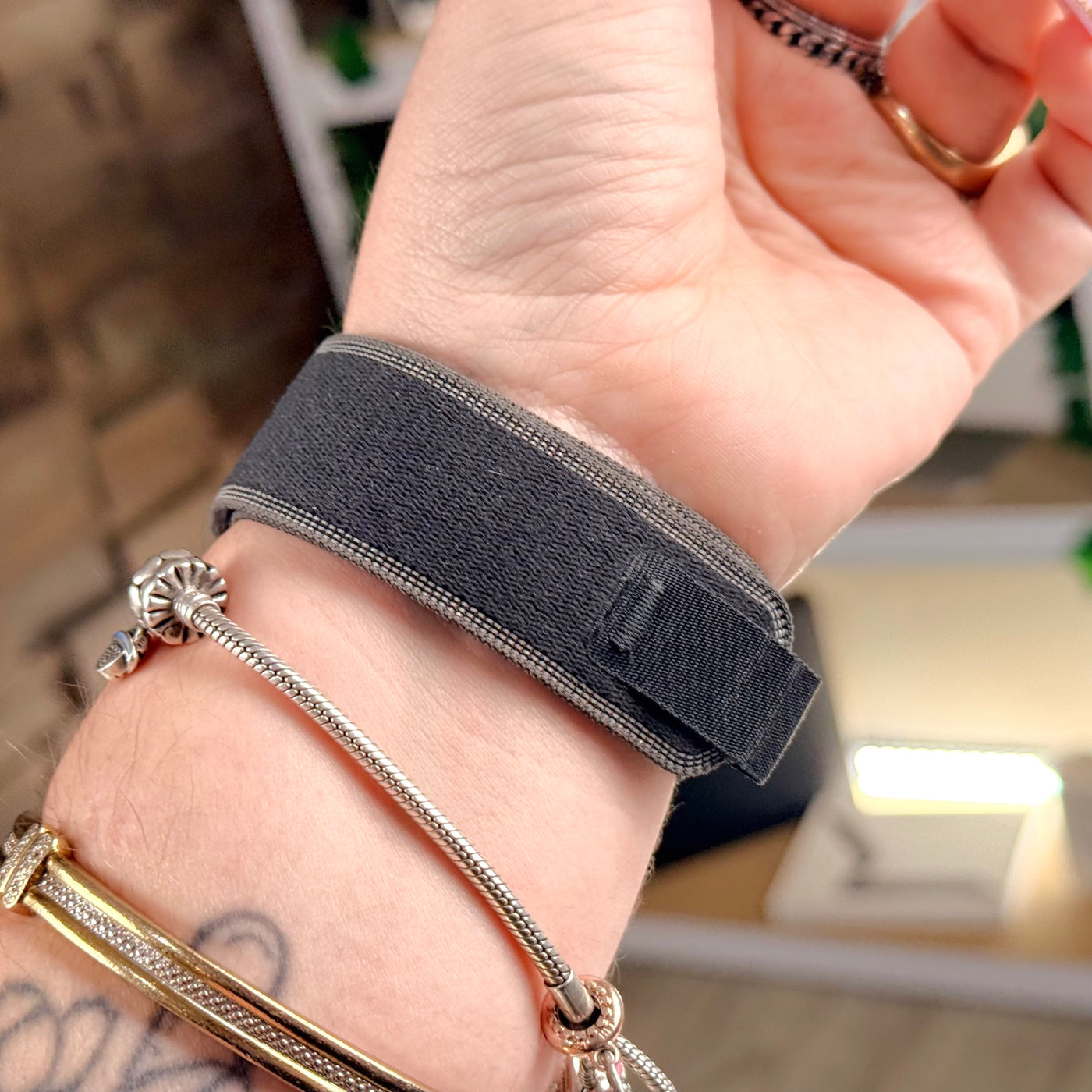Black/Charcoal Trail Loop band fastened on wrist, included with pre-owned Apple Watch Ultra 3 - MacShack