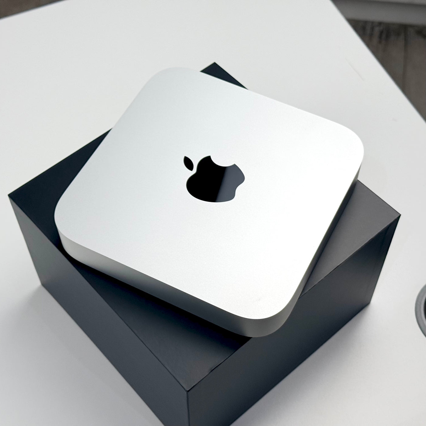Top view of the pre-owned Mac mini M2 Pro in Silver, resting on its box - Mac Shack