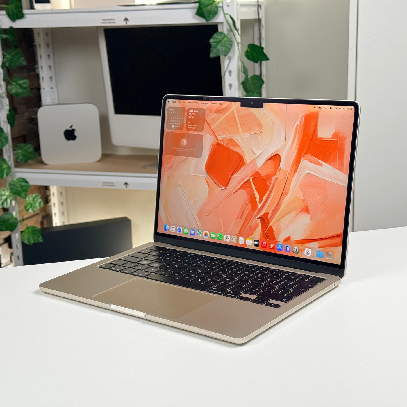Pre-owned MacBook Air 13-inch M2 Starlight angled side view, open with screen on - MacShack