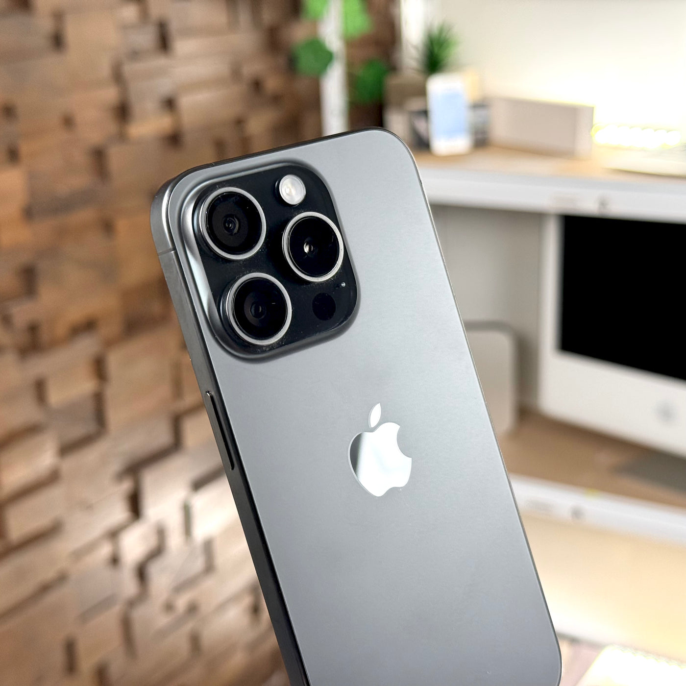 Pre-owned iPhone 15 Pro Black Titanium, close-up of the back and Pro camera system