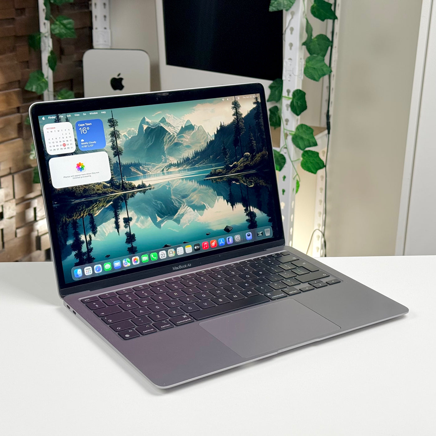 Pre-owned MacBook Air M1 in Space Gray, open on a desk with the screen on - Mac Shack