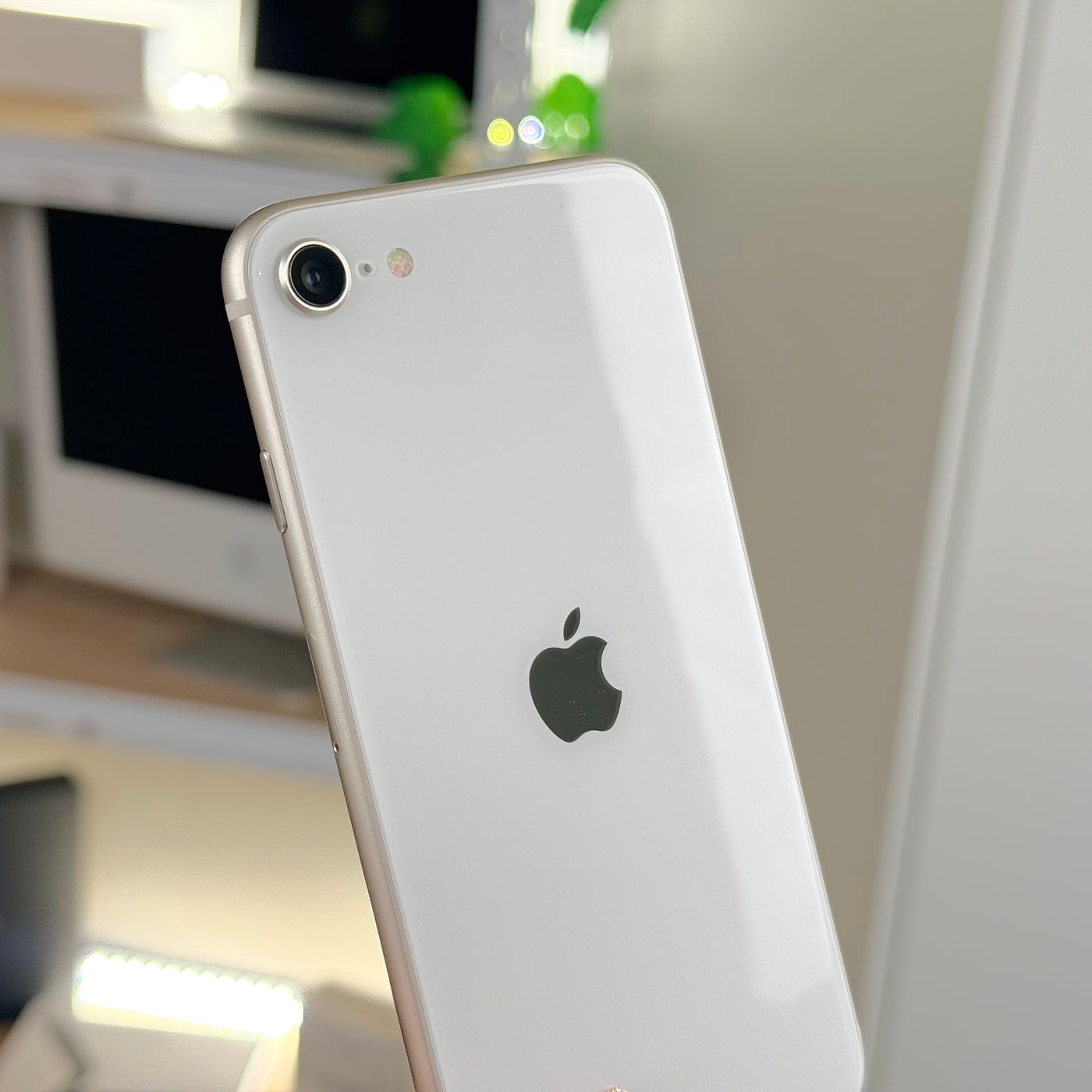 Back of pre-owned iPhone SE 3rd Gen Starlight showing single rear camera - Mac Shack