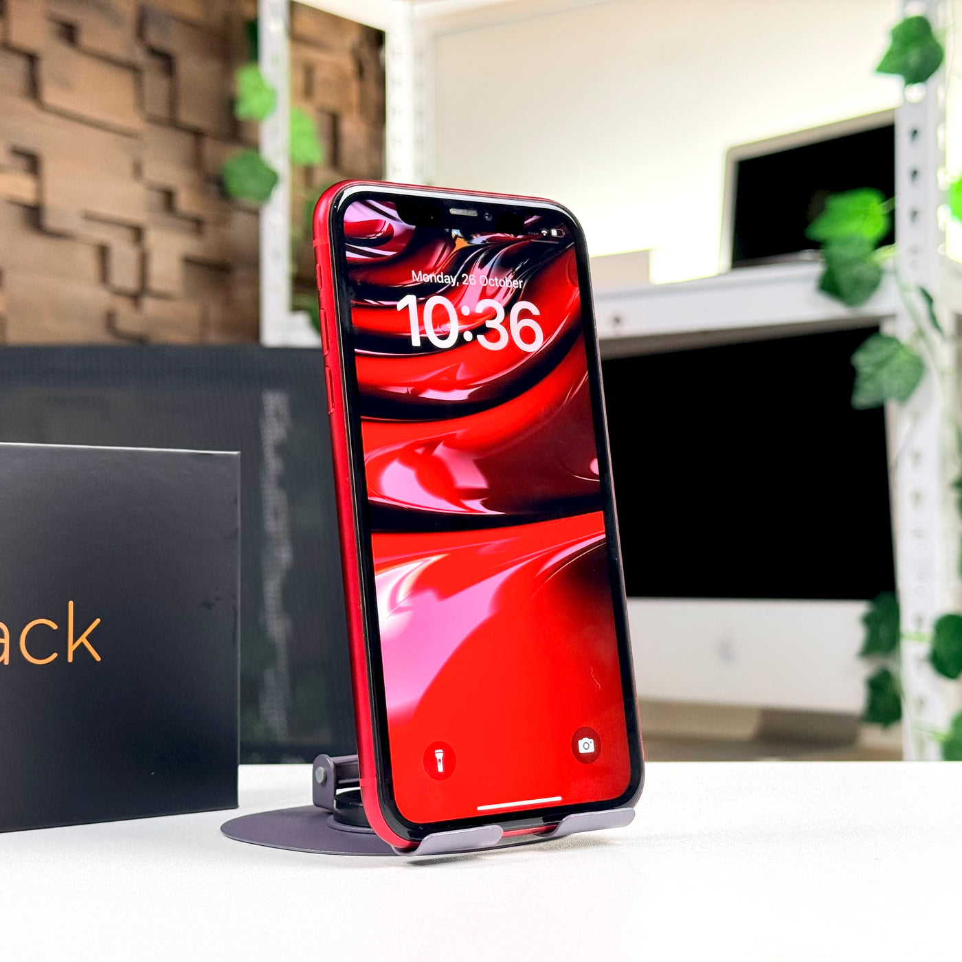 Pre-owned iPhone 11 Red standing upright on desk, front screen view - Mac Shack