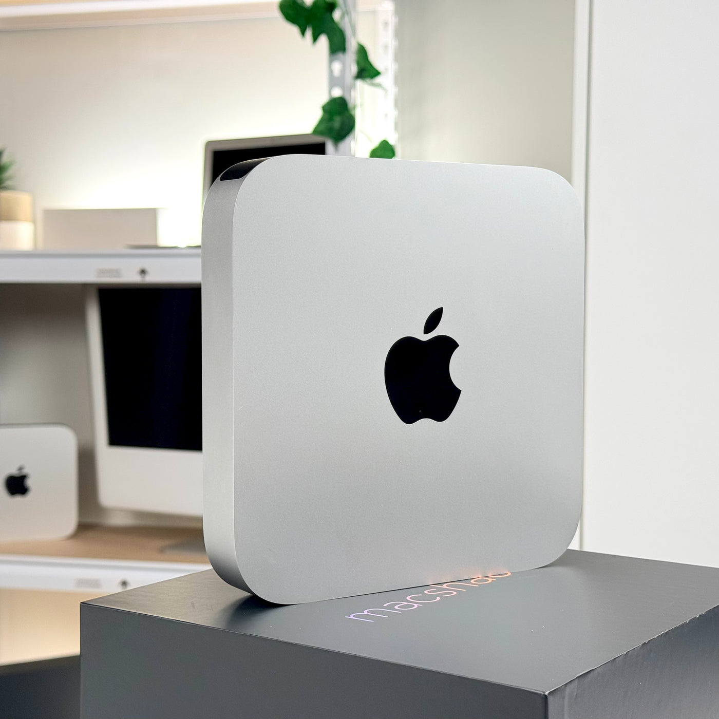 Pre-owned Mac mini M2 Pro standing on its side, showing the Apple logo - Mac Shack