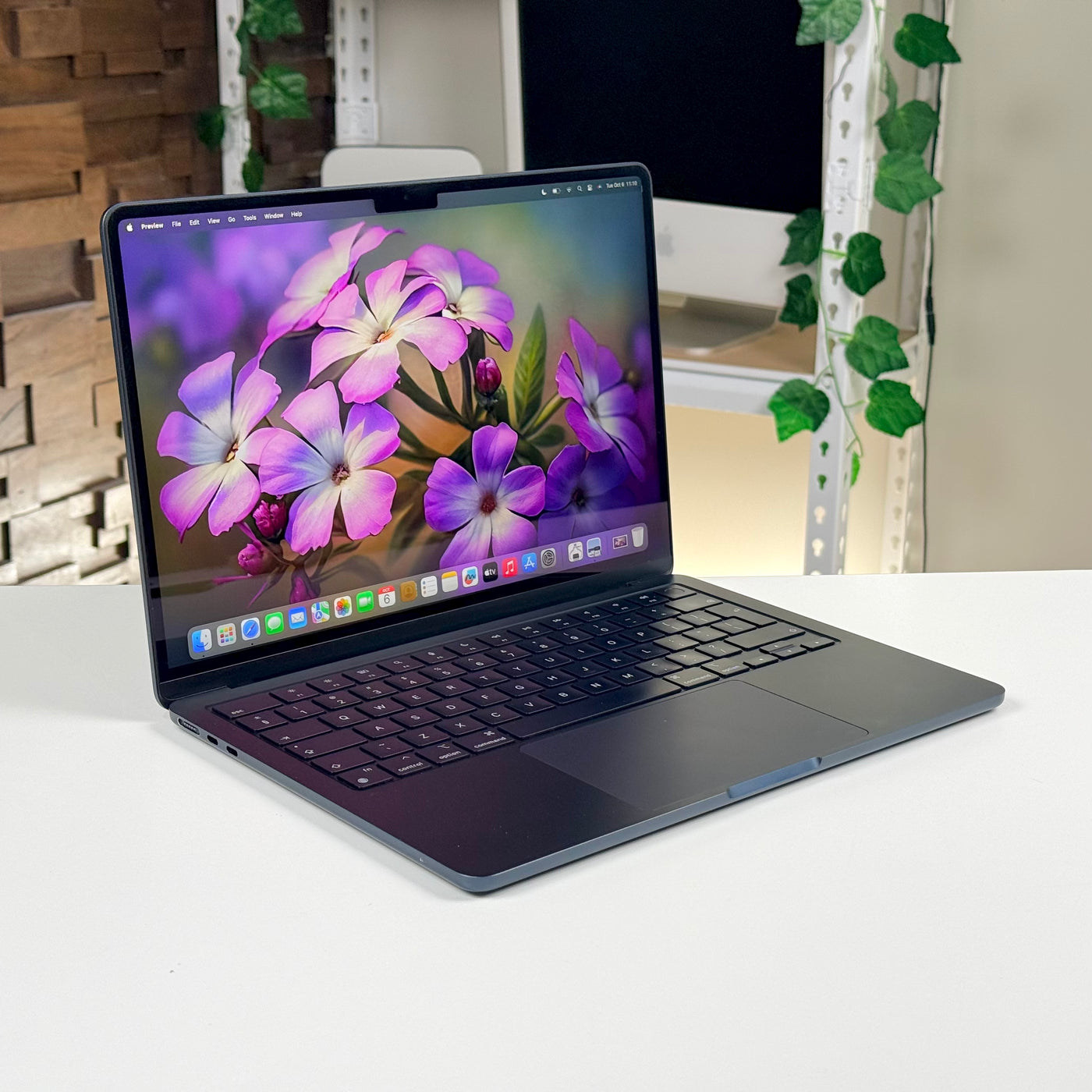 Pre-owned MacBook Air 13-inch M3 in Midnight, open at an angle on a desk - Mac Shack