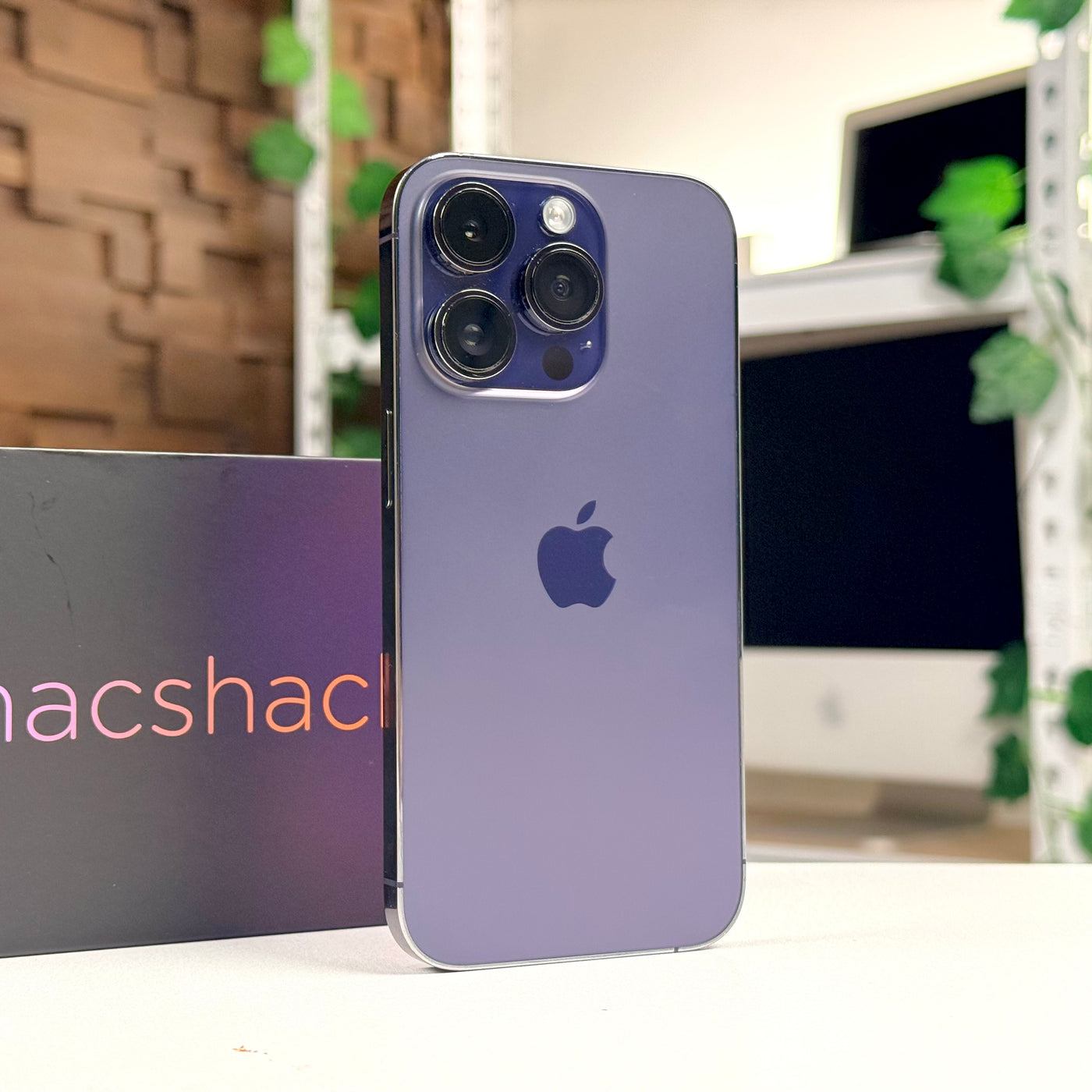 Back of a pre-owned iPhone 14 Pro 256GB in Deep Purple, standing upright - Mac Shack