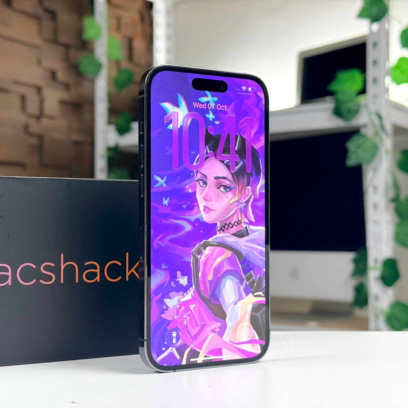 Pre-owned iPhone 14 Pro Deep Purple standing upright with the display on - Mac Shack