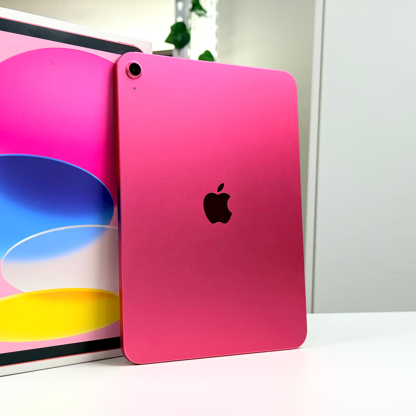 Pre-owned iPad 11-inch A16 Pink back view standing beside original box - MacShack