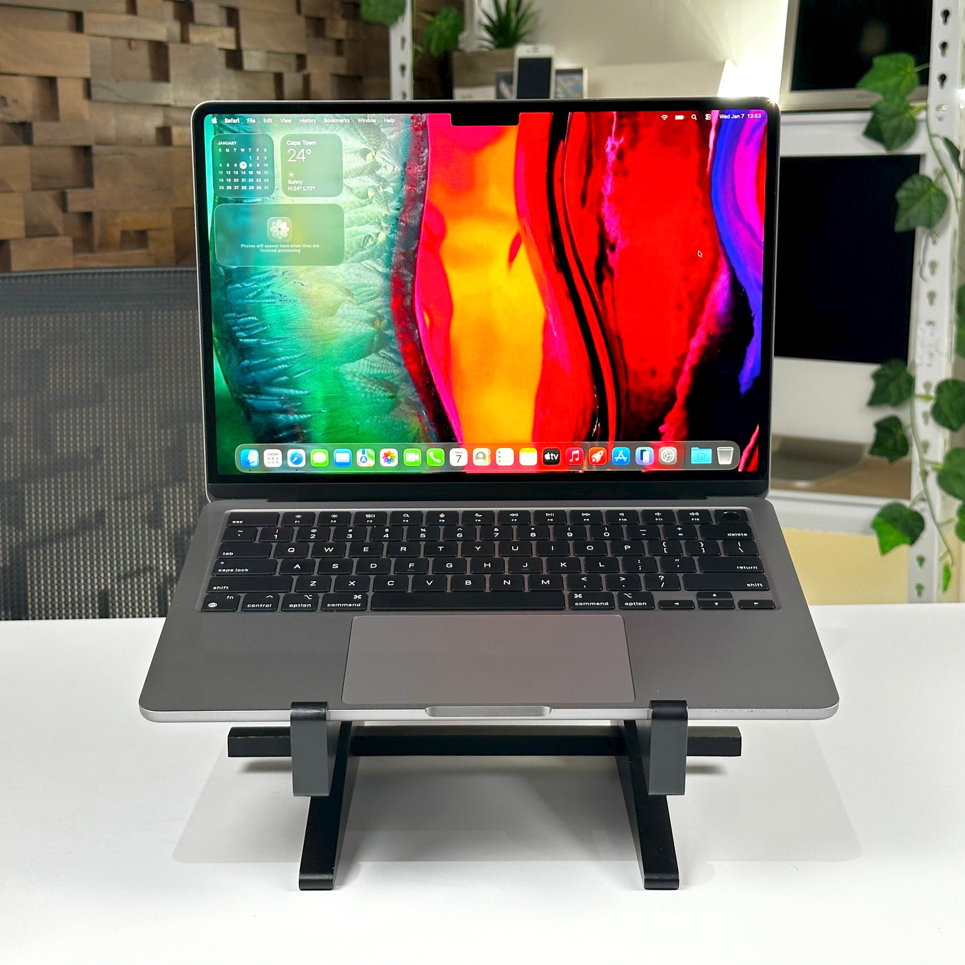 Front view of the pre-owned MacBook Air M2 in Space Gray, open on a laptop stand - Mac Shack