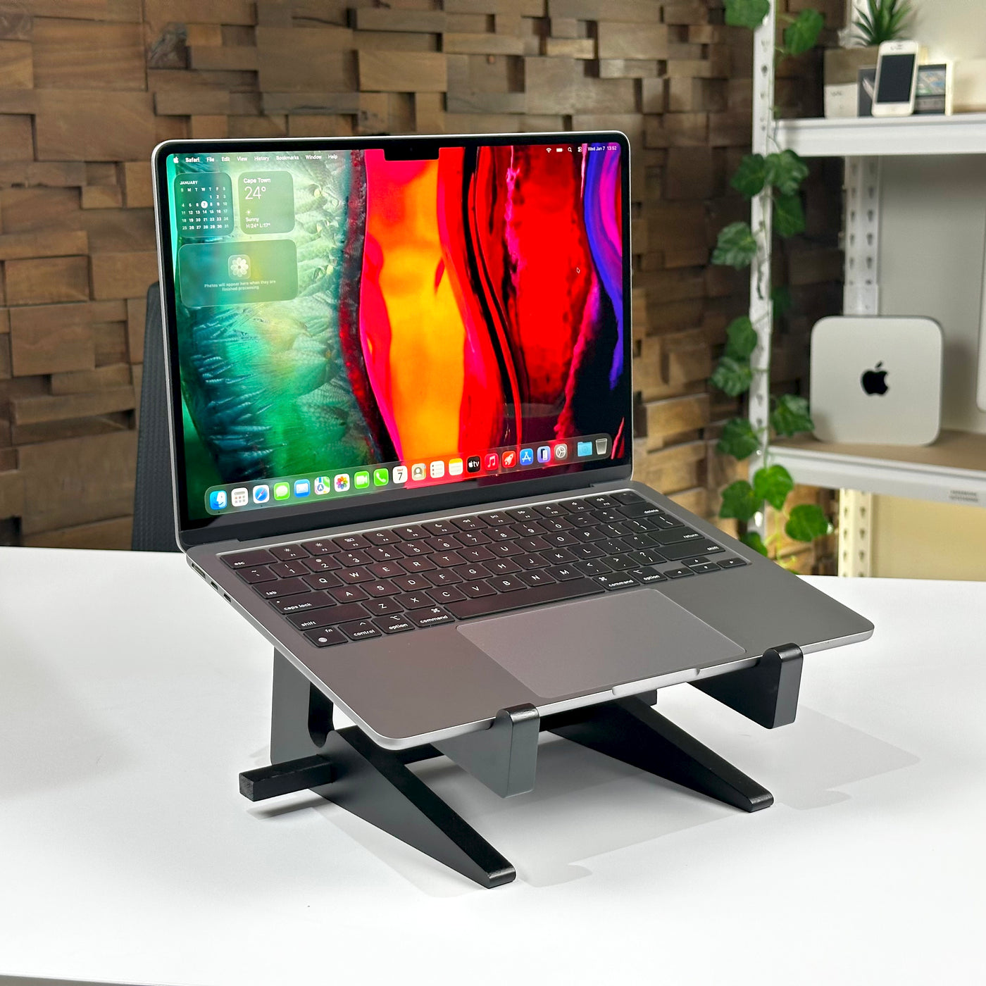 Pre-owned MacBook Air M2 in Space Gray, open on a laptop stand - Mac Shack