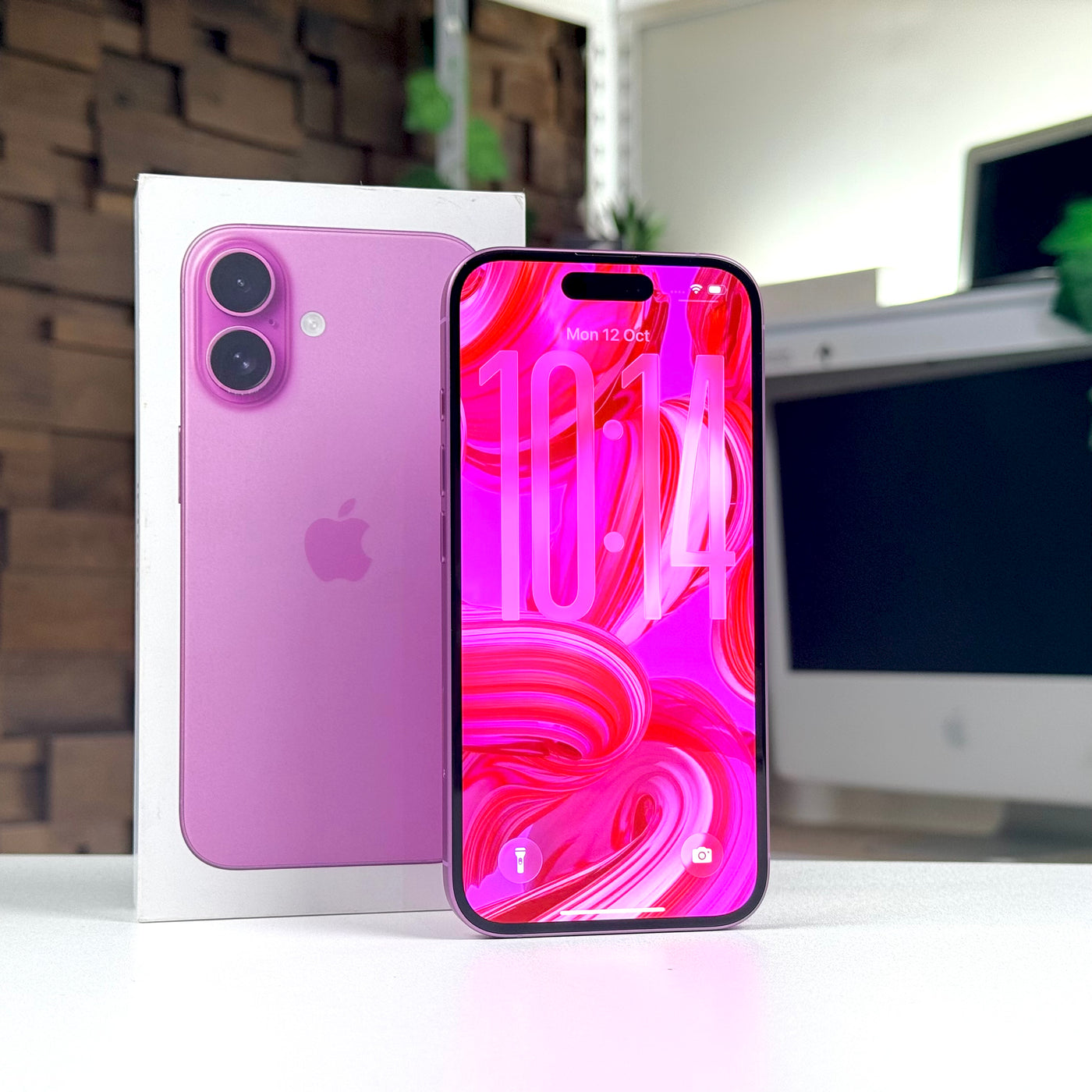 Pre-owned iPhone 16 Pink standing upright with the display on - Mac Shack