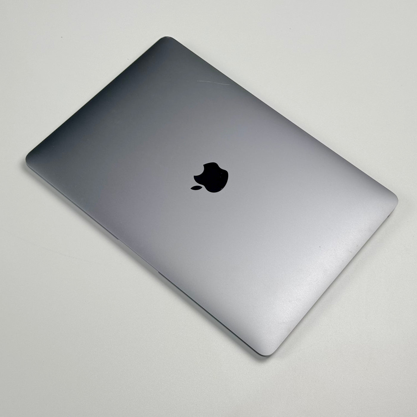 Top view of the closed pre-owned MacBook Air M1 in Space Gray, showing light wear on the lid - Mac Shack