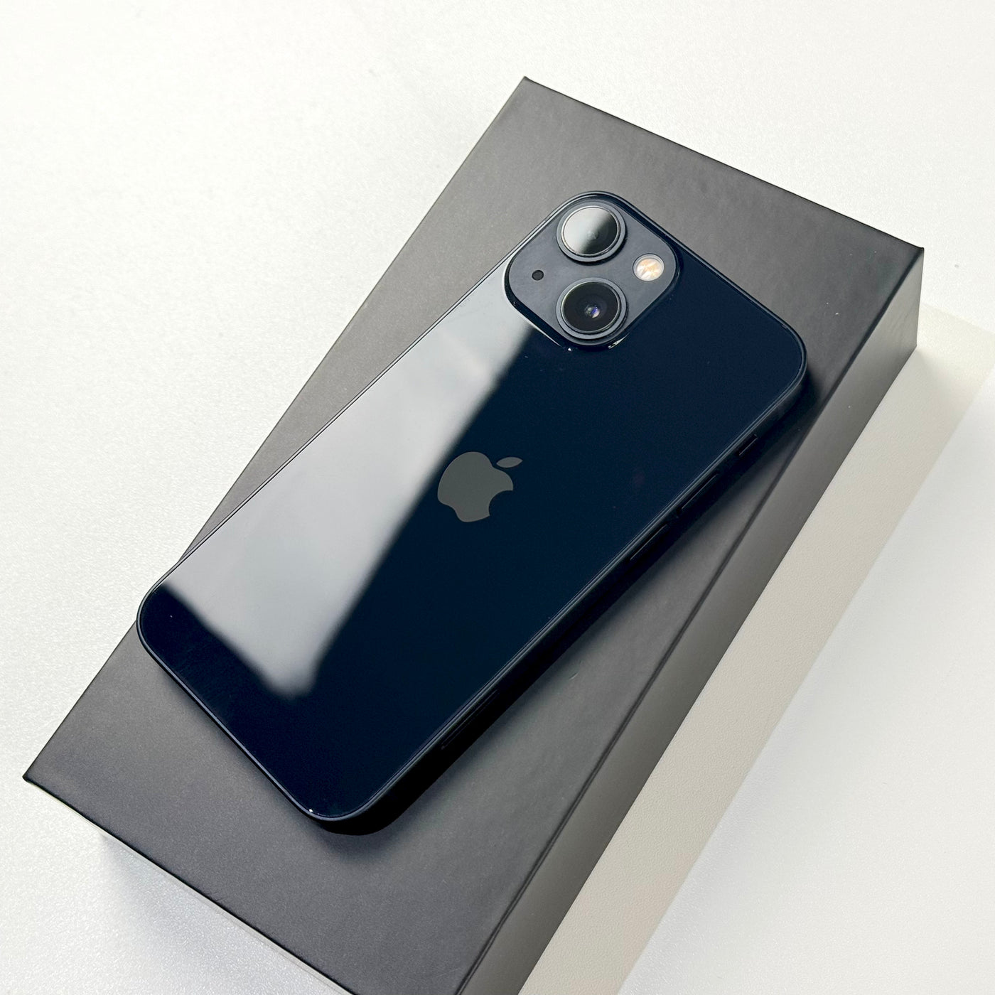 Back of pre-owned iPhone 13 mini Midnight in box showing dual camera - Mac Shack
