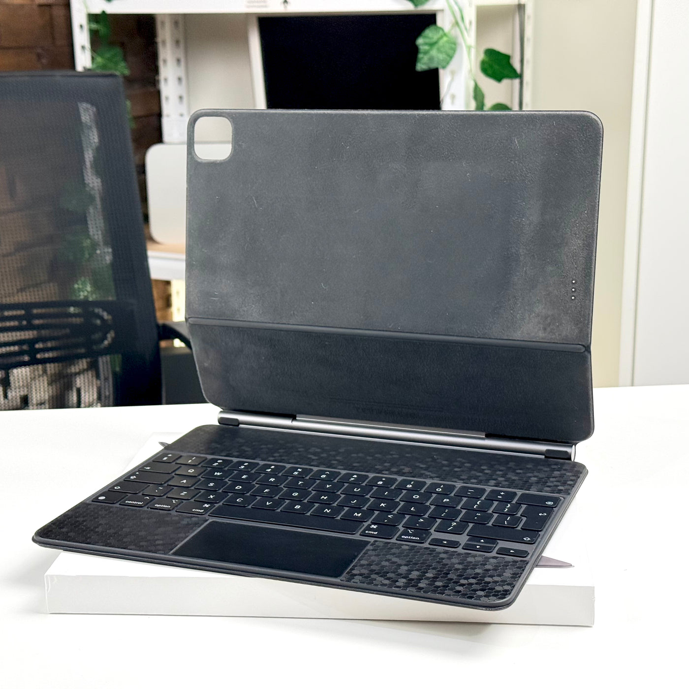 Pre-owned Apple Magic Keyboard 12.9-inch with an iPad Pro attached in the floating cantilever position